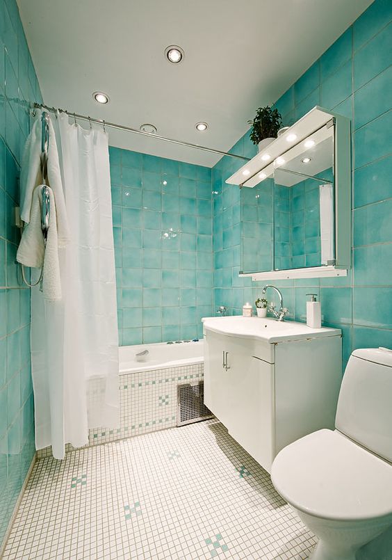 Turquoise Tile Walls and Mosaic Floor Create a Refreshing Bathroom