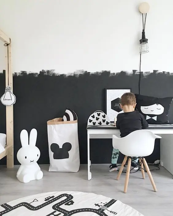 Textured Black Wall Creates a Bold Backdrop for Playful Decor