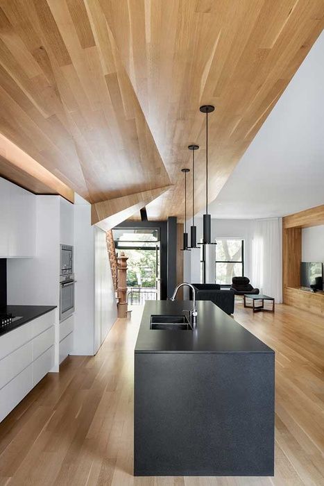 Define Your Open-Concept Space with a Dark Stone Island Base