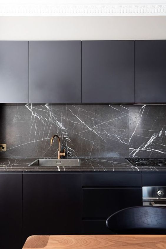 Dramatic Marble Backsplash Continues Onto Countertops