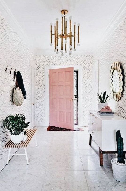 Pink Door Adds a Playful Pop Against Dotted Wallpaper
