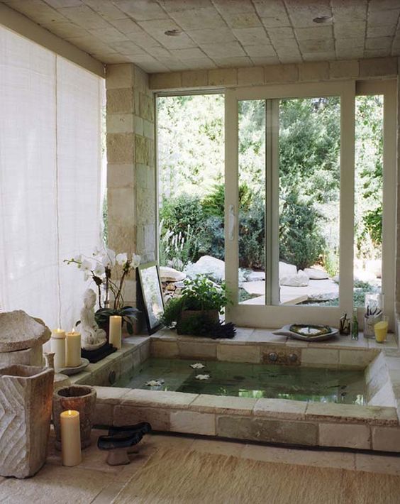 Stone Bathtub With Floating Flowers and Candles