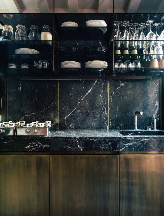 Glassware Displayed On Thin Shelves Above Dark Countertops
