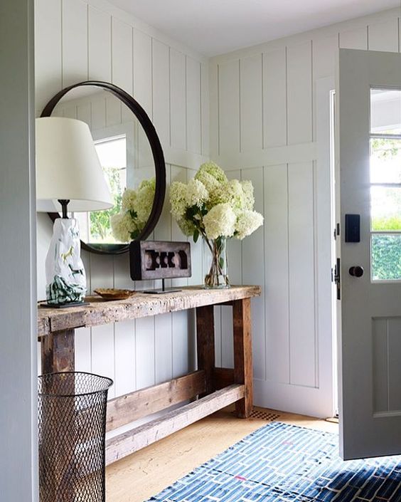 Anchor Your Entryway with a Weathered Wooden Console and Round Mirror