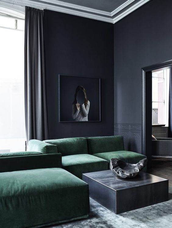 Deep Emerald Velvet Sofa Anchors a Moody, Dark Room