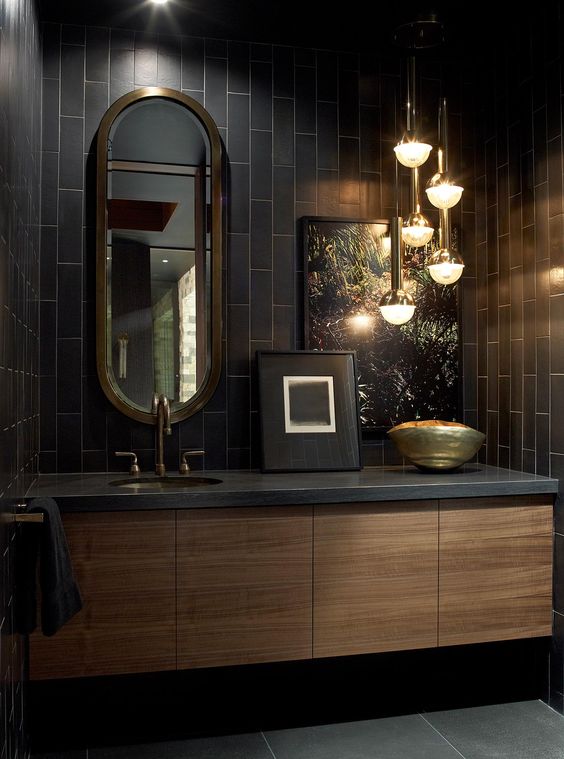 Soften Dark Tiles with an Oval Brass Mirror