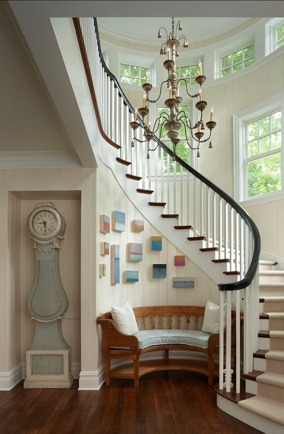 Grouped Small Paintings Add Color to Stairwell Wall