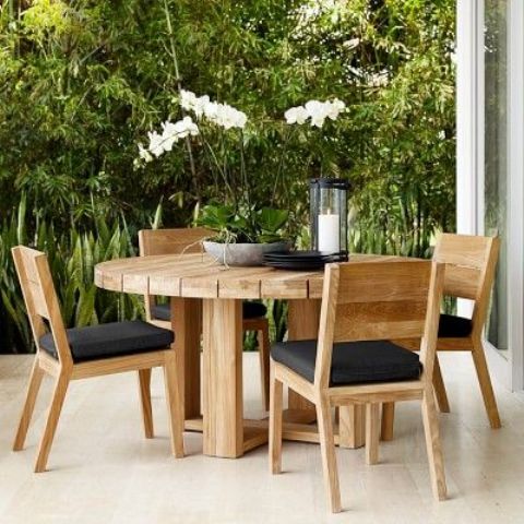 Round Teak Dining Table With Natural Orchid Centerpiece