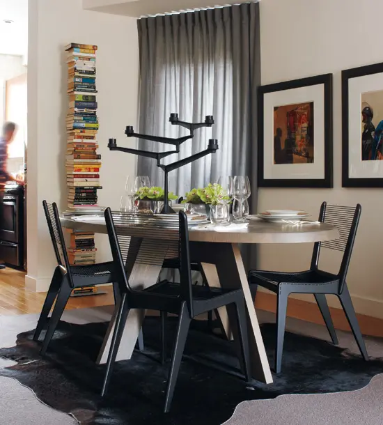 Tall Book Stack Adds Vertical Interest to Dining Space