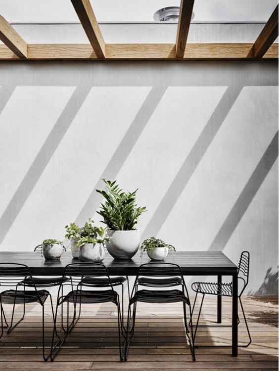 Round Planters Add Softness to a Modern Dining Set