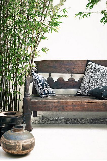 Choose a Dark Wooden Bench with Patterned Cushions for Rustic Seating