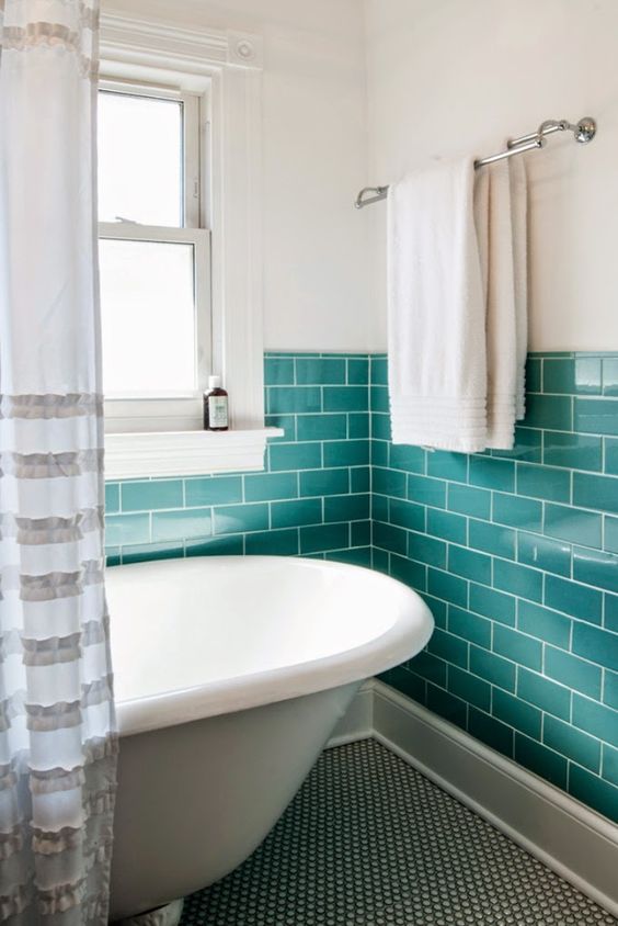 Turquoise Subway Tile Walls Frame a Freestanding Tub