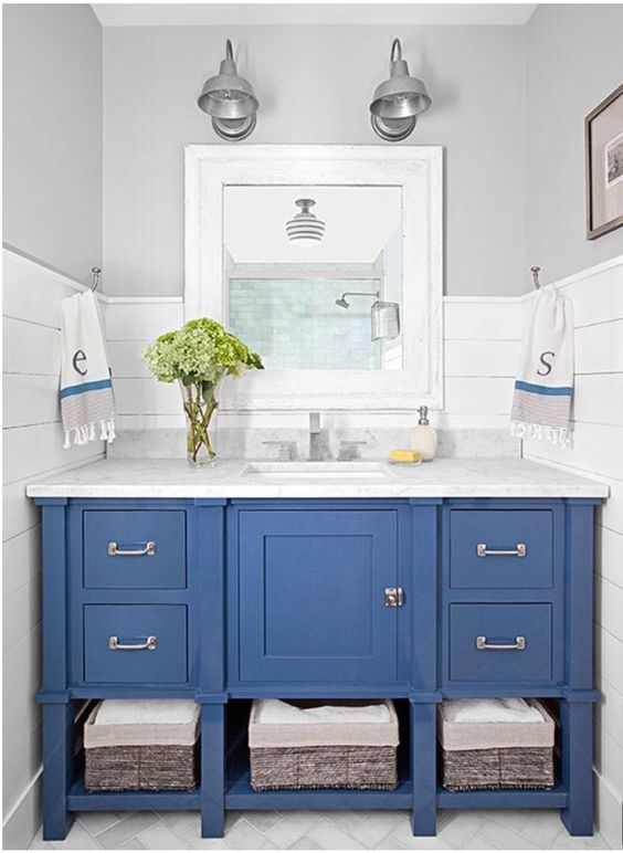 Woven Baskets Store Linens Under a Blue Vanity