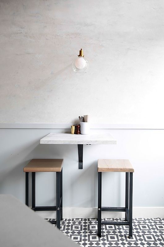 Achieve a Modern Look with a Marble Countertop and Minimalist Stools