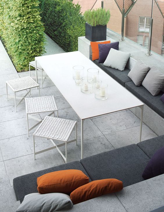 White Woven Stools Add Casual Seating Around a Long Table