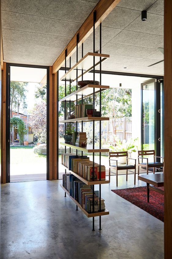 Floating Shelves Create an Open Room Divider With Books