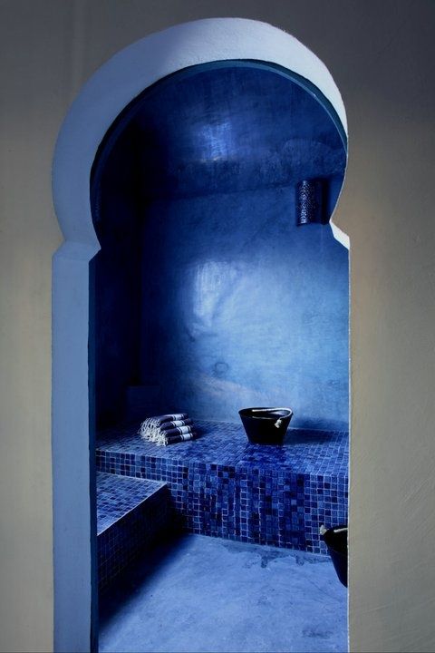Tiled Alcove With Built-in Seating and Black Buckets