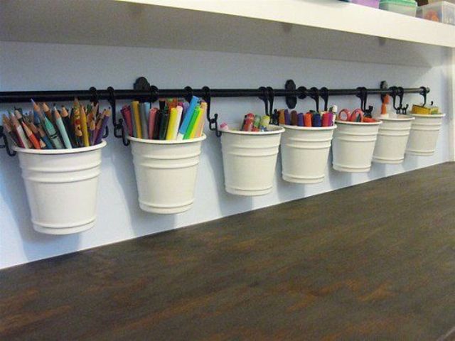 White Buckets Hung From A Rail Organize Art Supplies