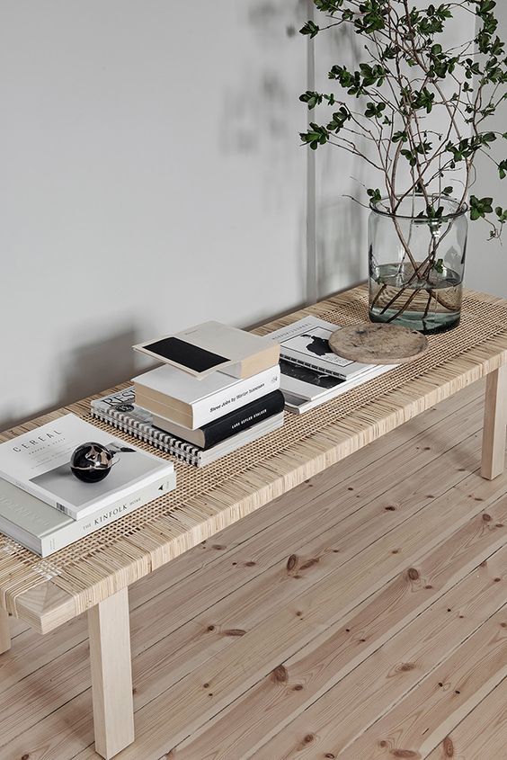 Stack Books and Decor on a Rattan Bench for a Layered Look