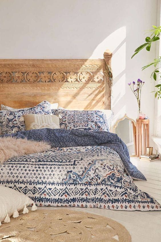 Carved Wooden Headboard Adds Natural Texture Above Bed