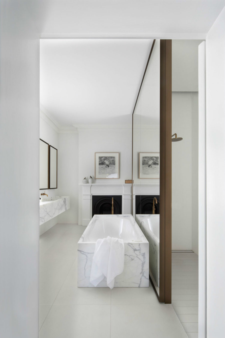 Marble Bathtub and Mirrored Wall Create a Spa-Like Retreat