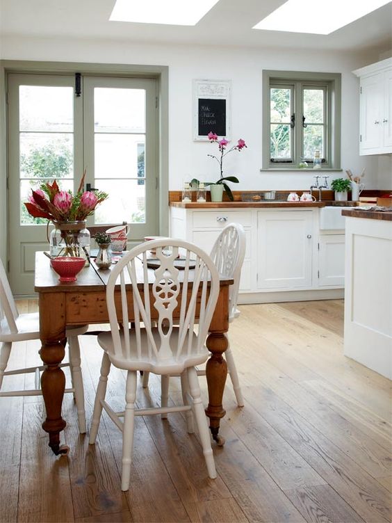 Wooden Table with Ornate White Chairs