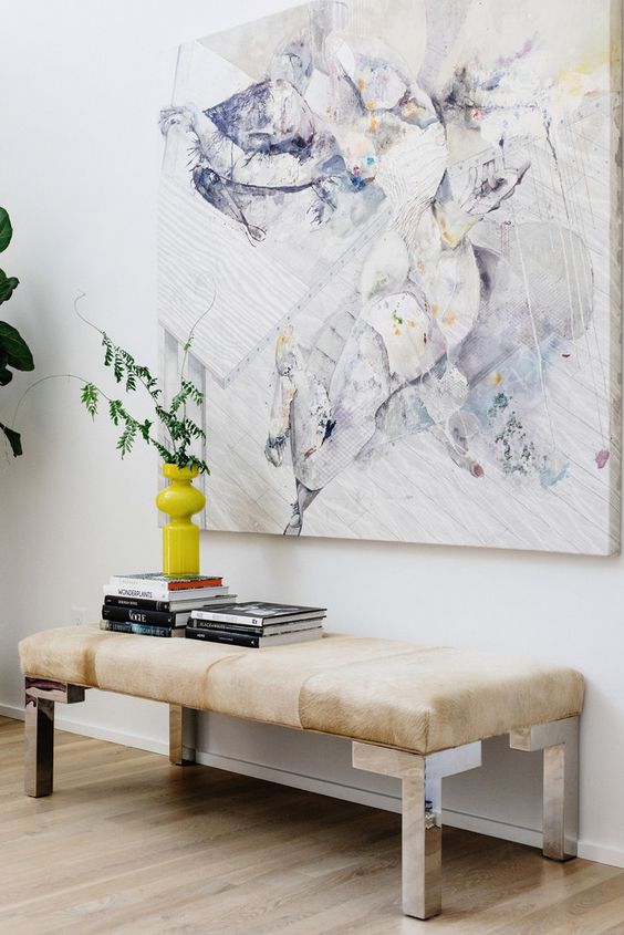 Stack Books on Your Entryway Bench for a Pop of Color