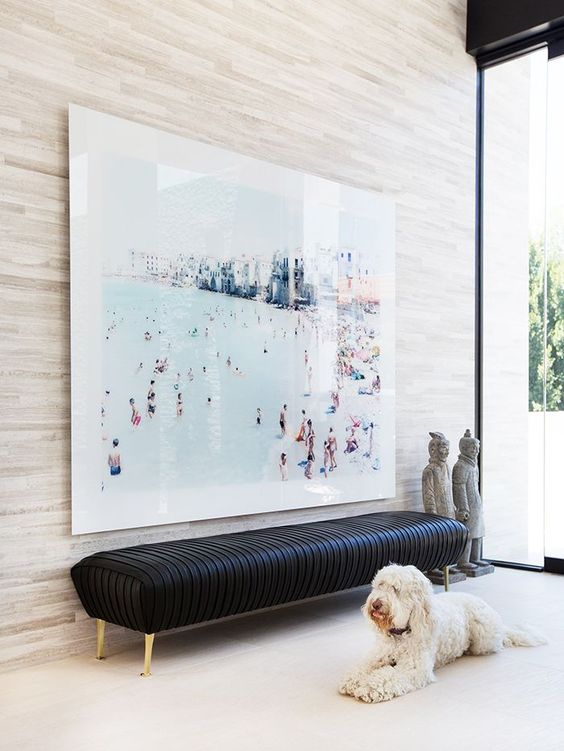 Artwork and Bench Anchor a Black Entryway