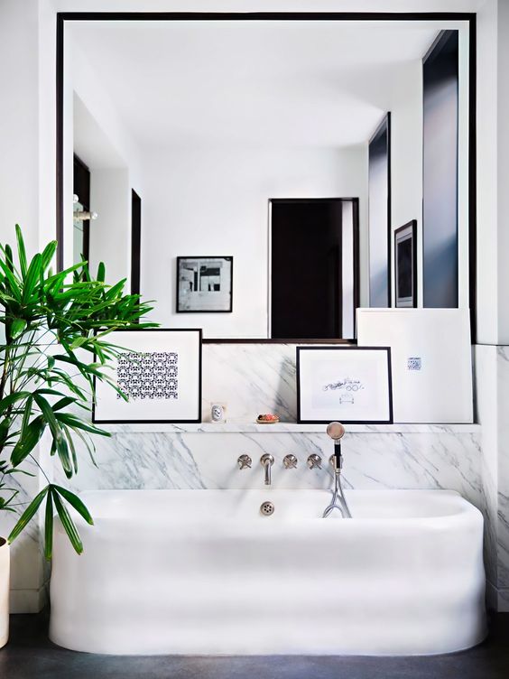 Lean Framed Artwork on a Ledge Above the Bathtub