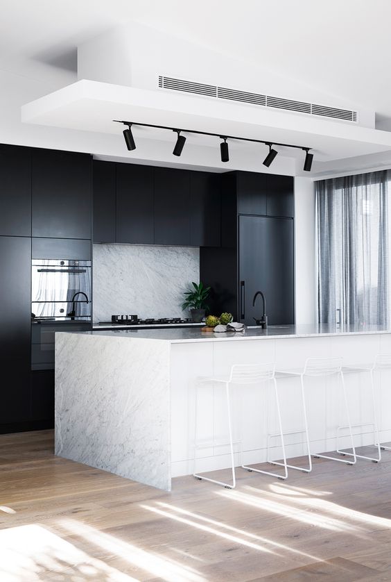 Marble Island Base With White Cabinetry Creates a Striking Contrast