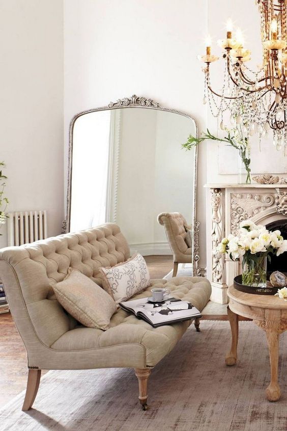 Ornate Arch-Top Mirror Adds Grandeur to a Seating Area