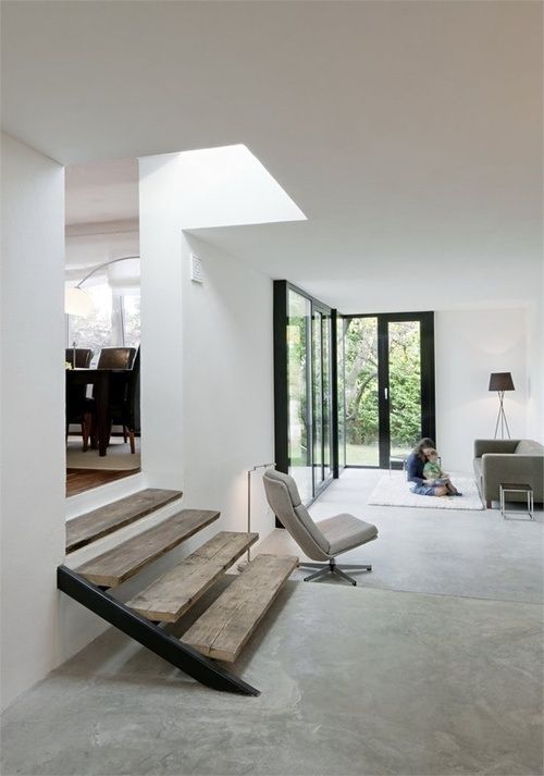 Incorporate Rustic Wooden Steps for Warmth in a Concrete Interior