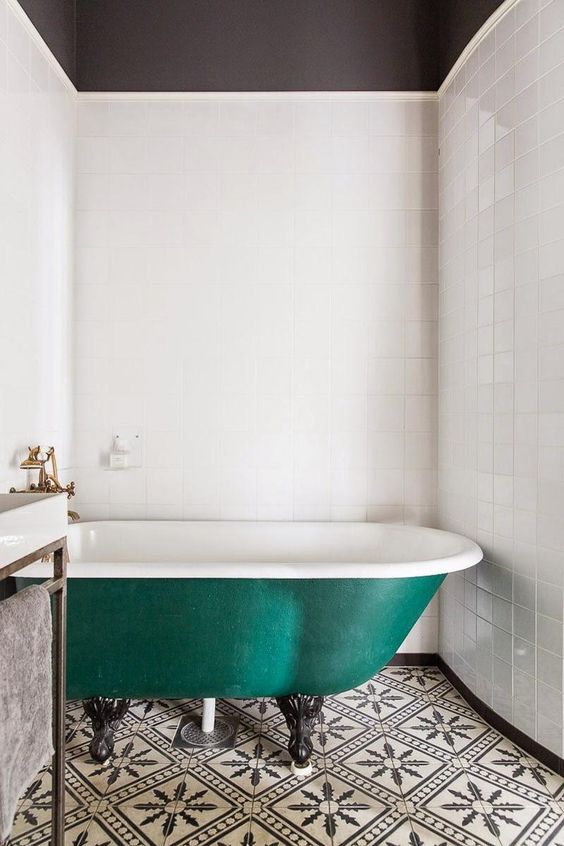 Deep Green Clawfoot Tub Anchors a Patterned Floor