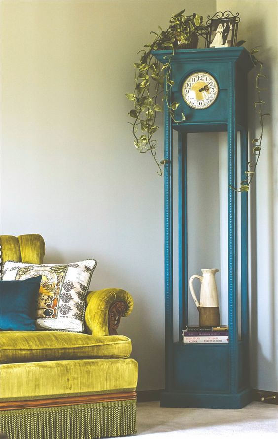 Teal Grandfather Clock With Cascading Greenery and Ceramic Pitcher