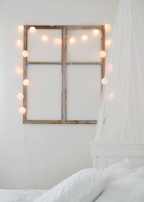 Ball String Lights Outline a Rustic Window Frame