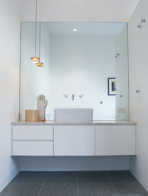 Floating Vanity with Vessel Sink Under a Large Mirror