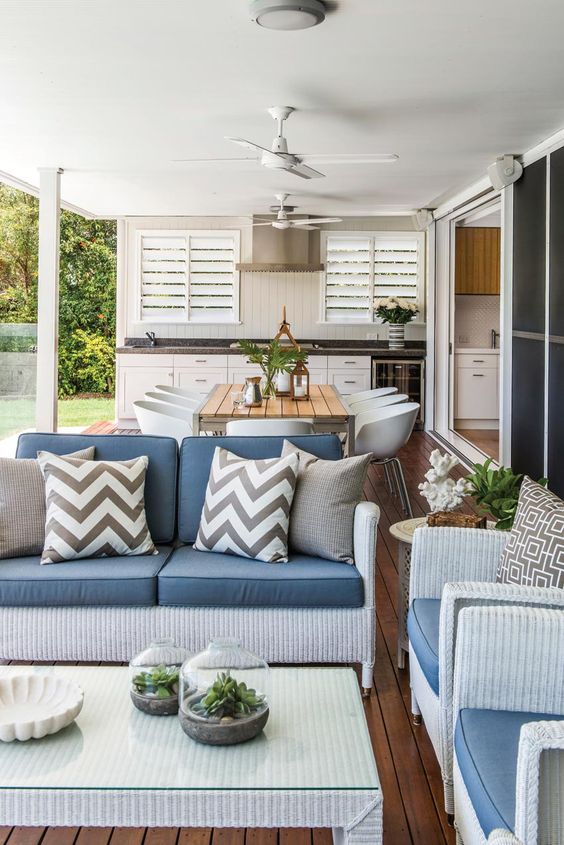 Outdoor Kitchen with Shutters and Wood Dining Set