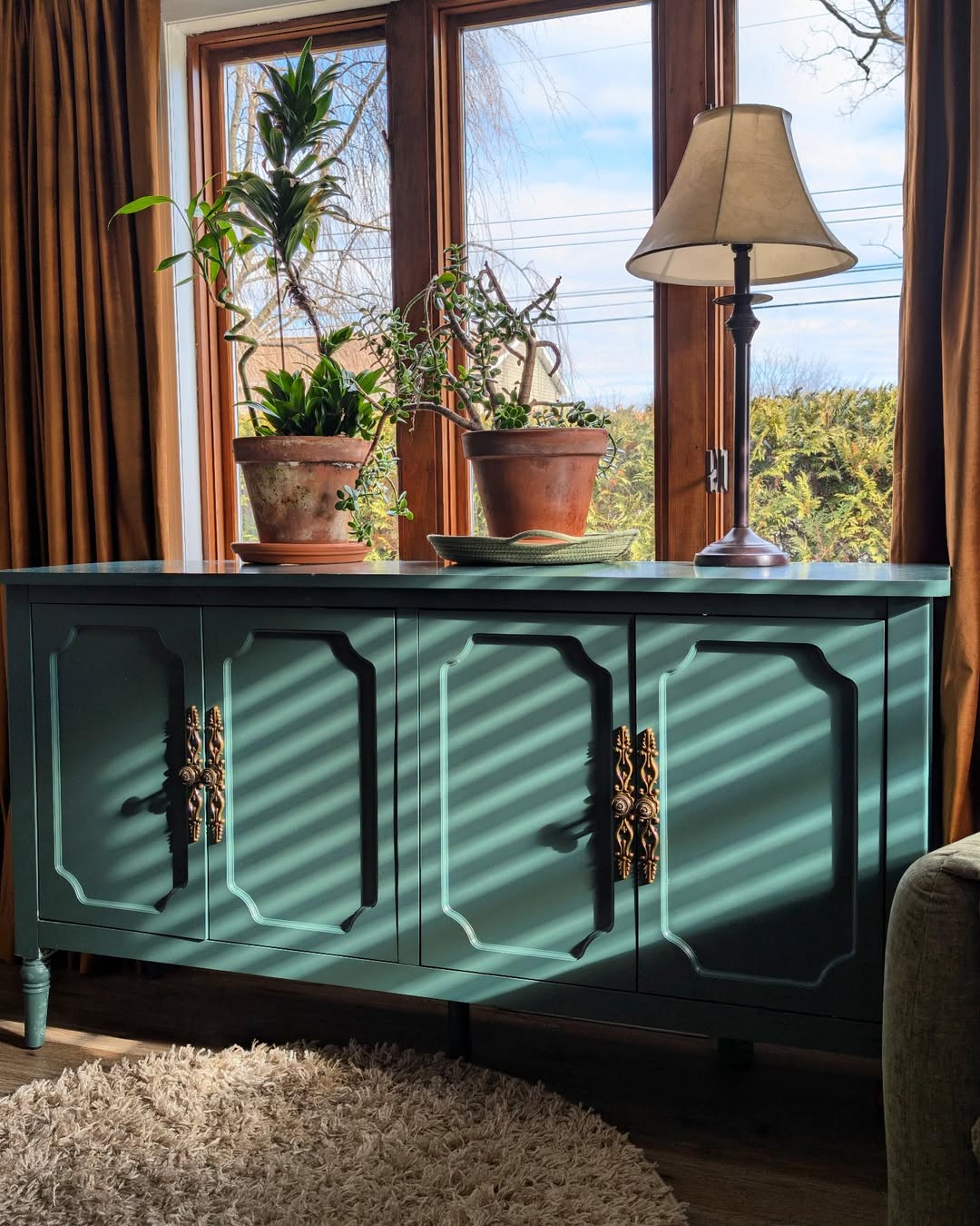 Terracotta Pots Add Earthy Charm to Green Cabinet