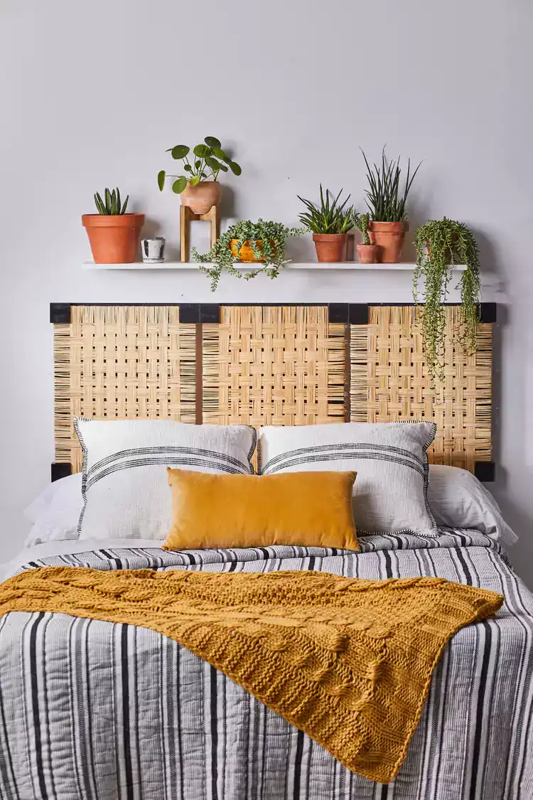 Floating Shelf Adds Greenery Above Woven Headboard