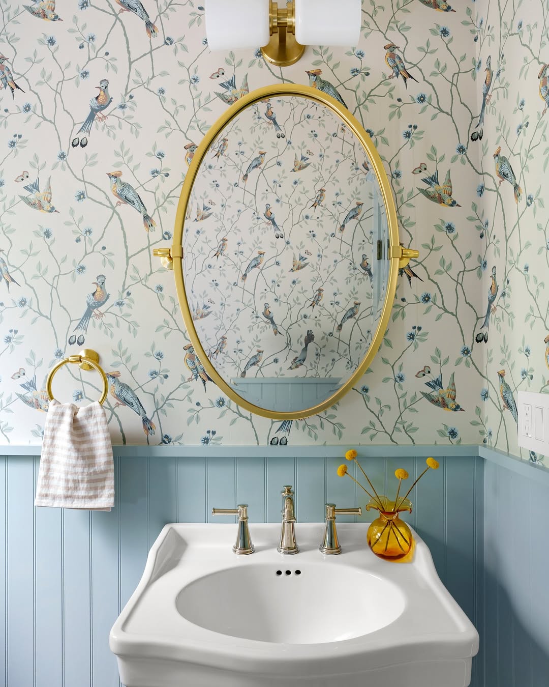 Reflect Whimsical Bird Wallpaper with an Oval Gold Mirror