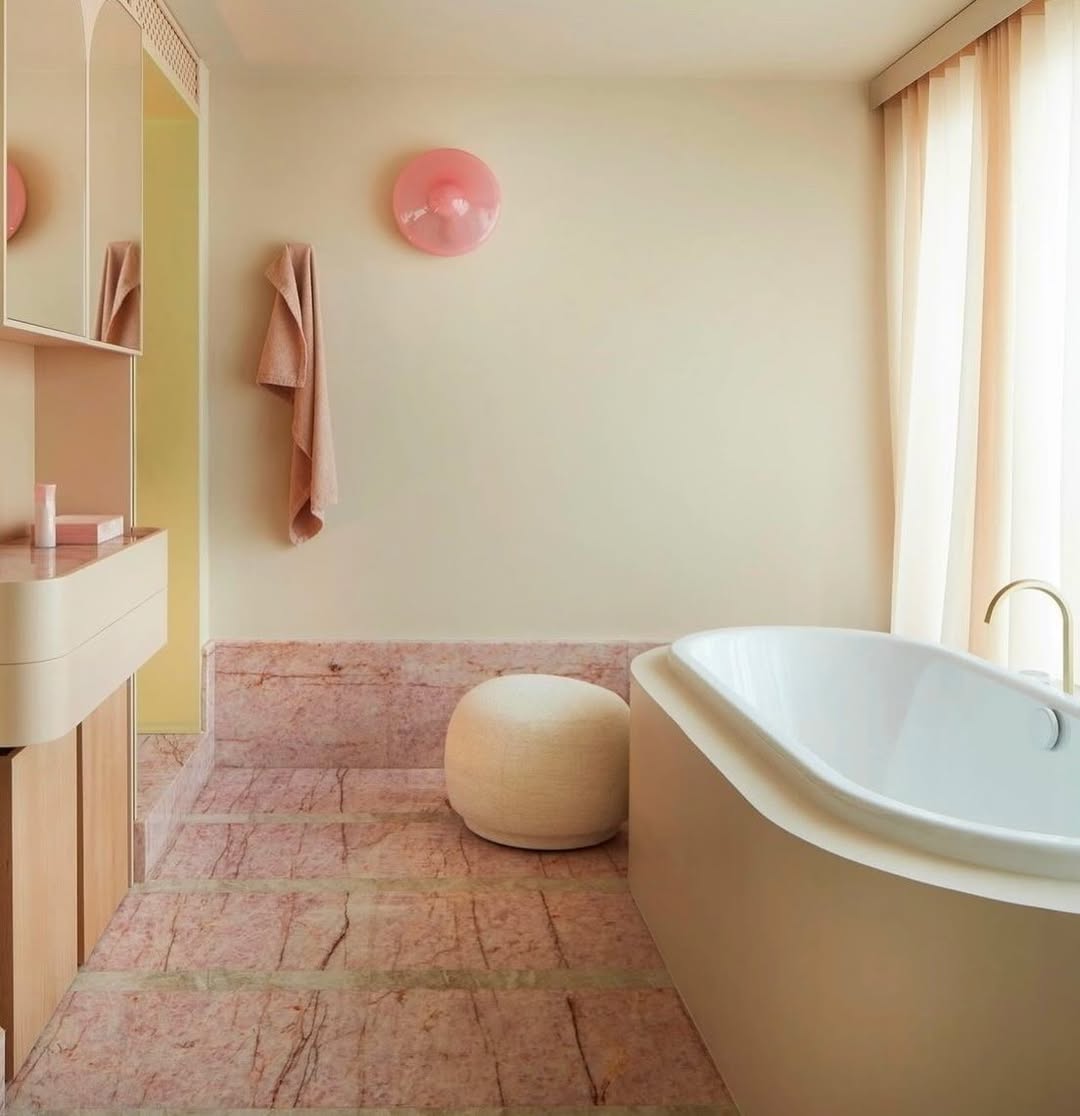 Round Pouf Adds a Soft Seating Option Near the Tub
