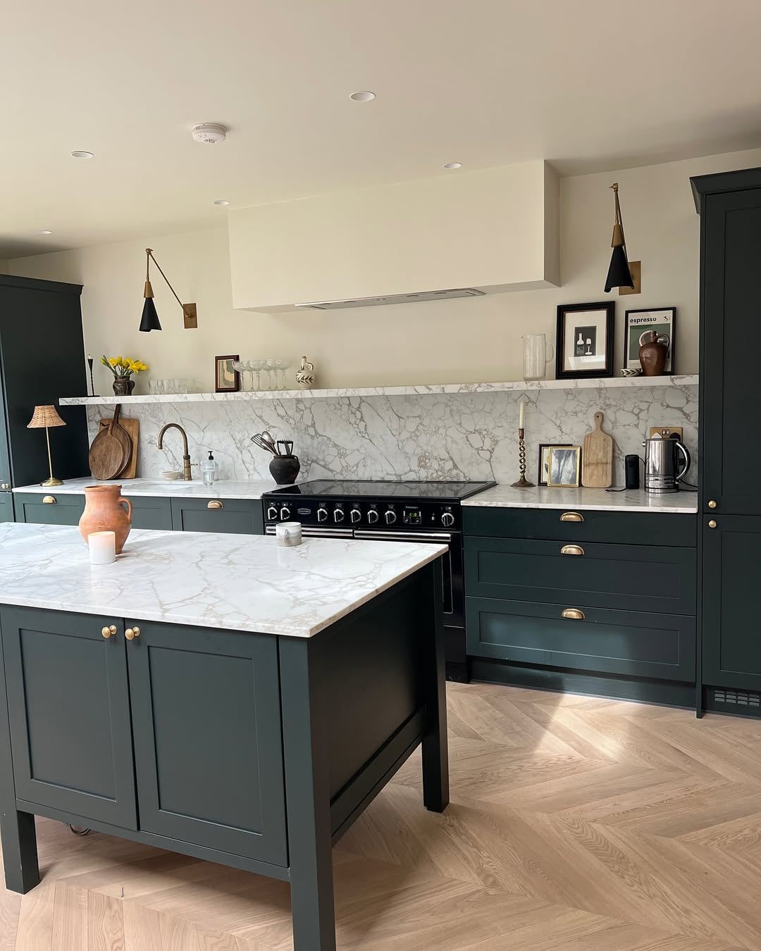 Dark Green Cabinets and Island Complement Marble Countertops
