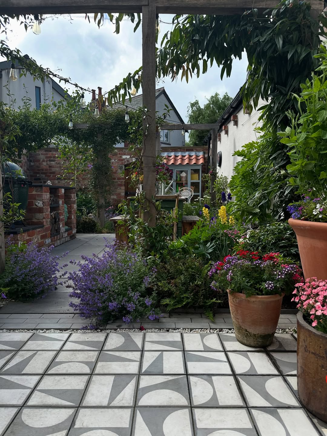 Terracotta Pots Add Warmth to Geometric Paved Patio
