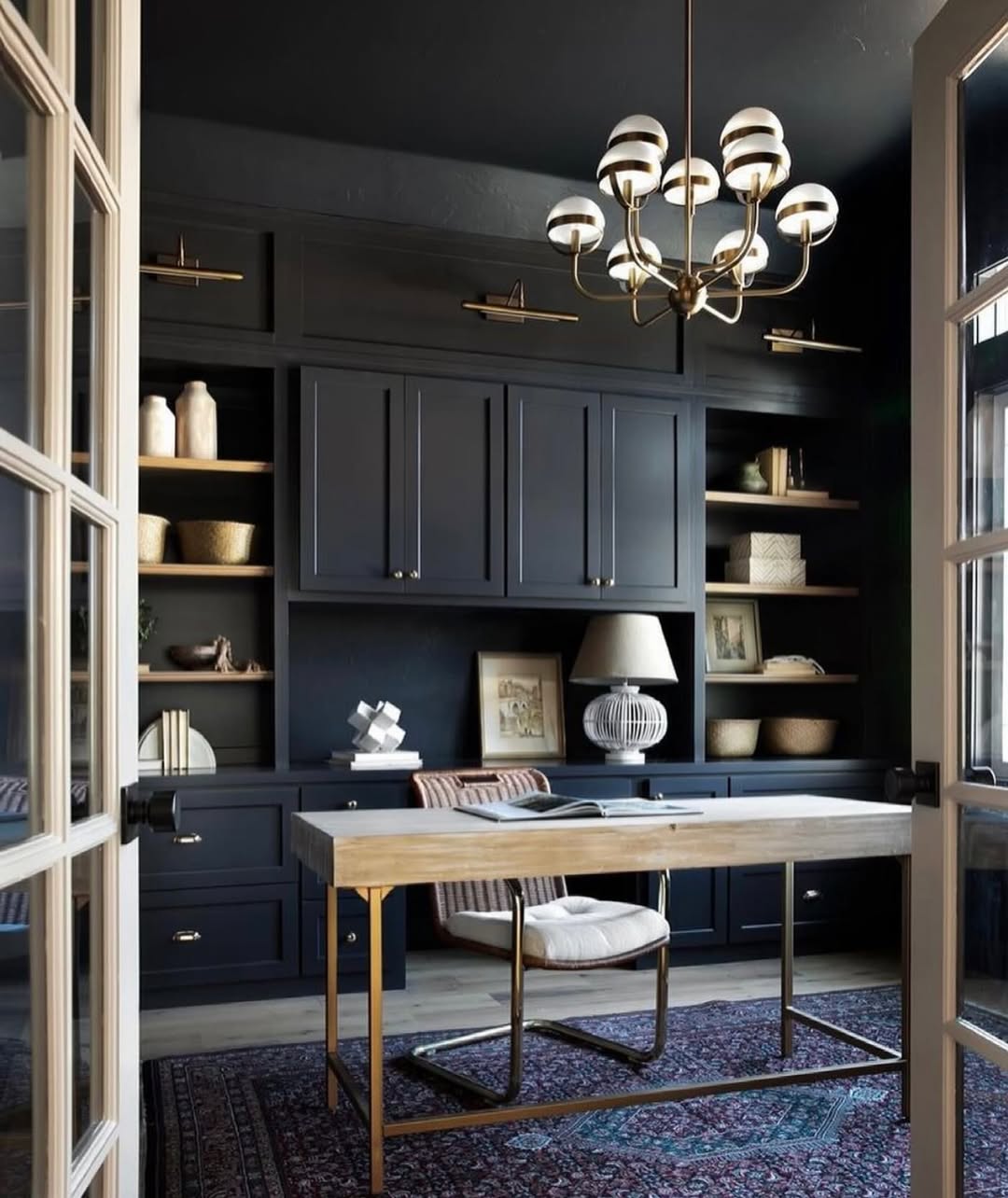 Dark Built-in Cabinetry Frames a Light Wood Desk