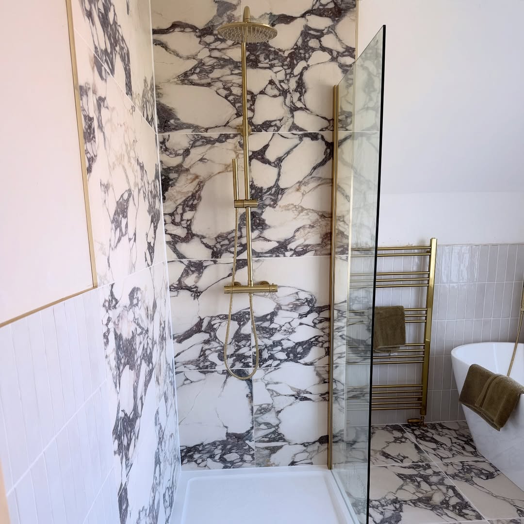 Gold Shower Fixtures Complement Dramatic Marble Walls