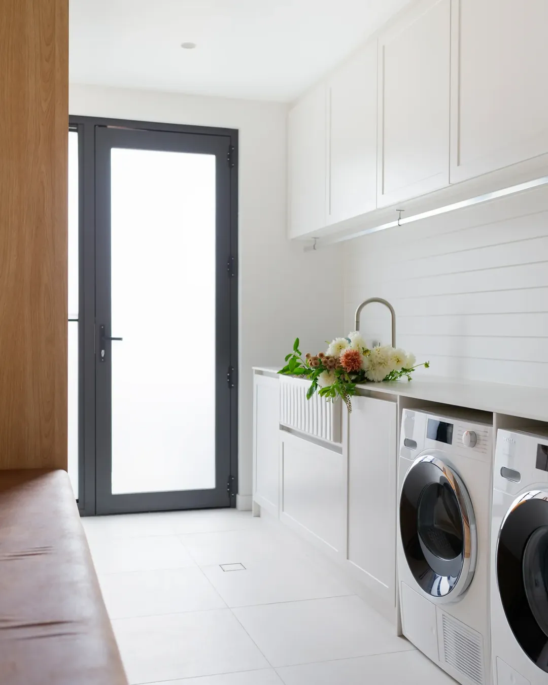 White Shiplap Wall Backs a Deep Farmhouse Sink