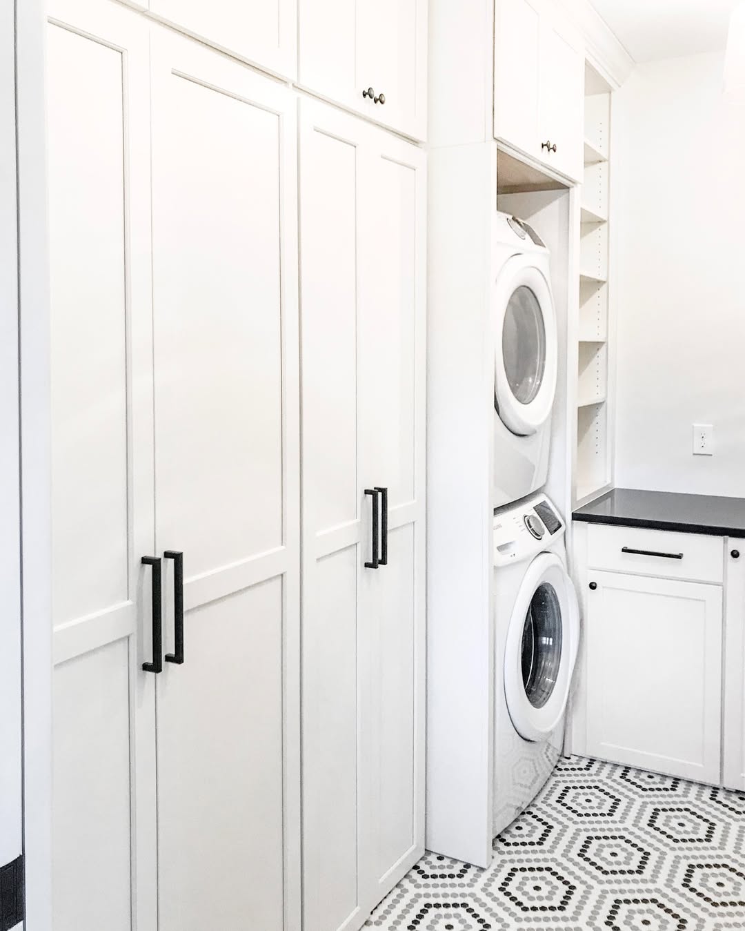 Frame Stacked Washer and Dryer With Tall White Cabinets