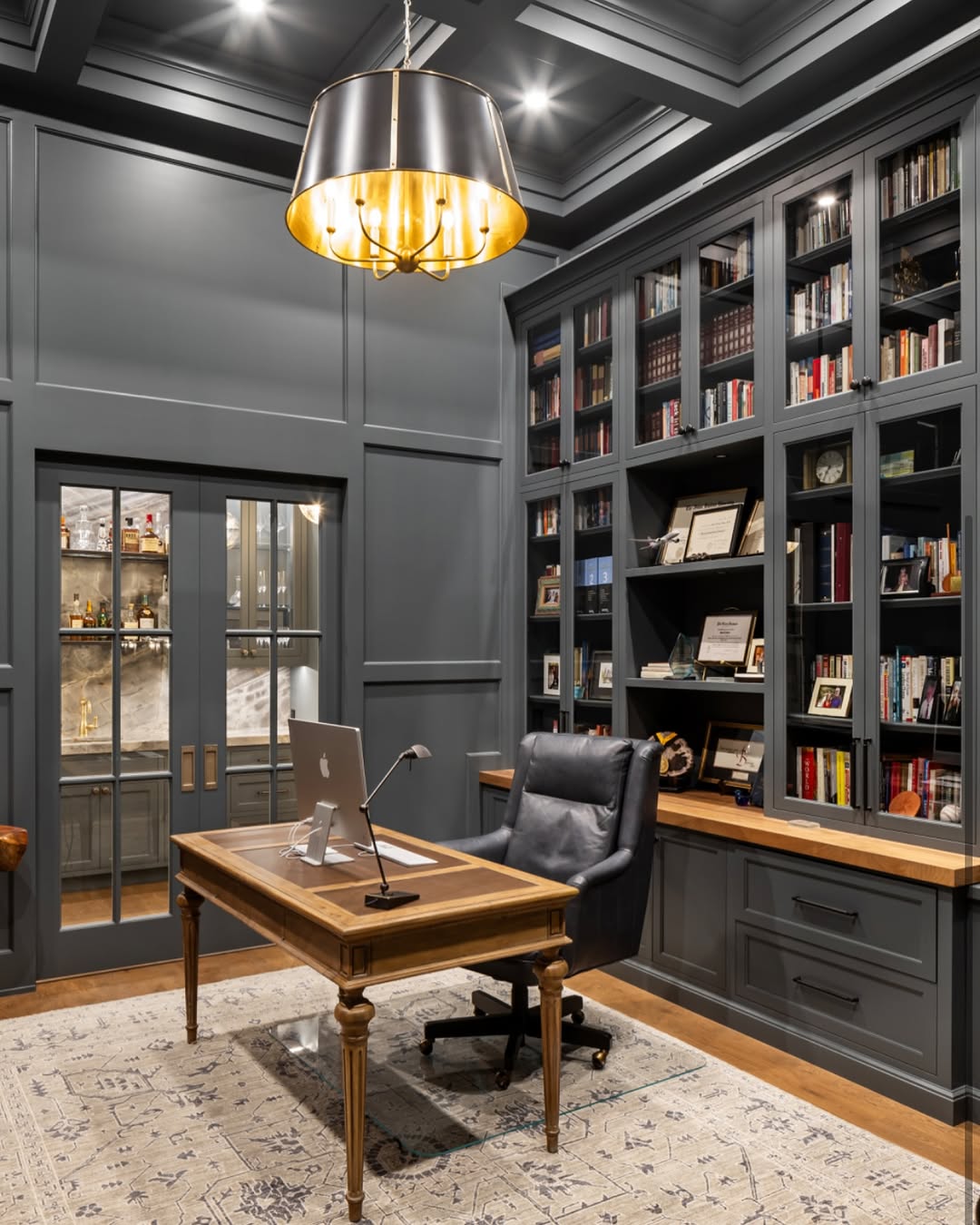 Dark Gray Built-Ins with Glass Doors Frame a Traditional Desk