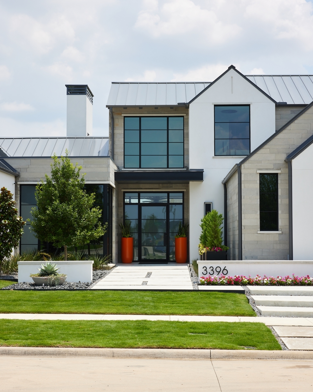 Tall Orange Planters Frame the Entryway