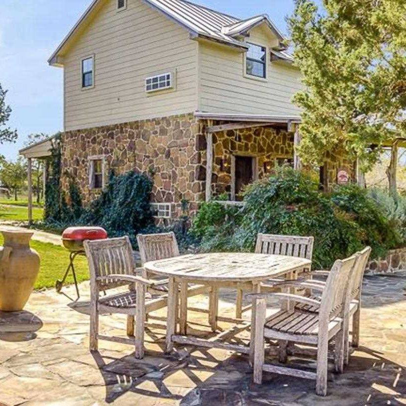 Dine Outdoors with Weathered Wooden Table and Chairs